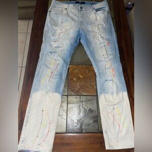 Men's Distressed Light Blue Jeans with paint splatter pattern.